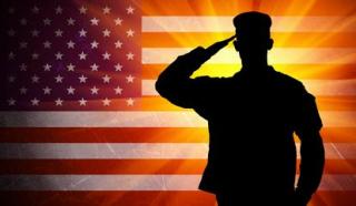 silhouette of a solider over an American flag 